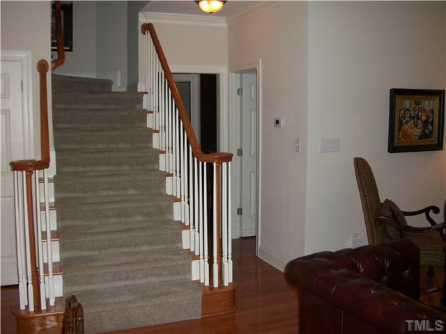 7318 Fontana Ridge Lane Raleigh, NC 27613 - Photo 8 of 23 The staircase to the upstairs with carpet runner...