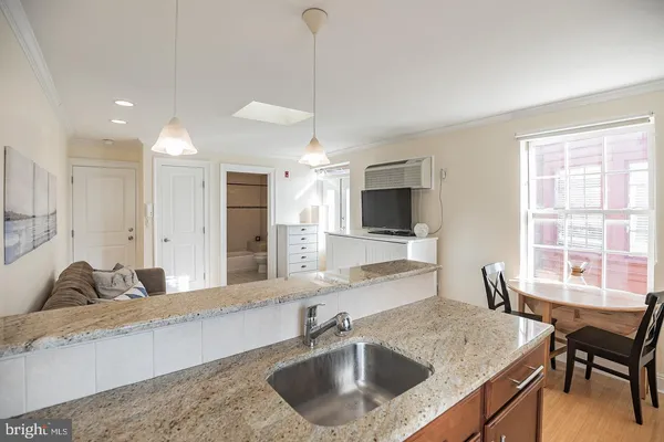 a kitchen with a stove a sink and a refrigerator