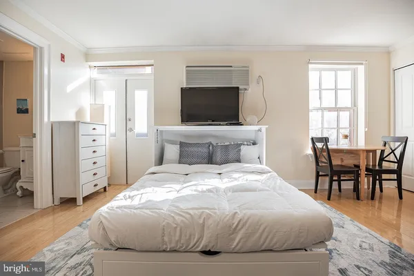 a bedroom with a large bed and a flat screen tv