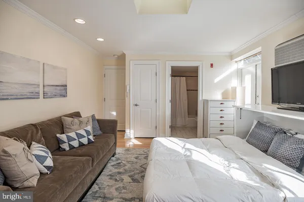 a spacious bedroom with a bed and couch