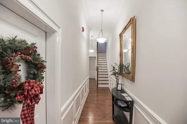 a view of a hallway and wooden floor