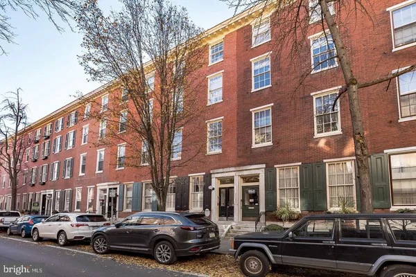 a car parked in front of a brick building