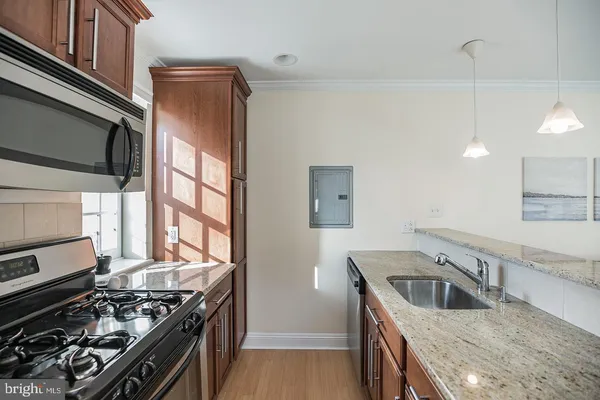 a kitchen that has a sink and a stove