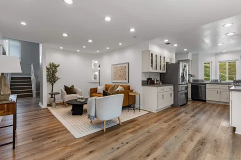 a open kitchen with white cabinets and stainless steel appliances