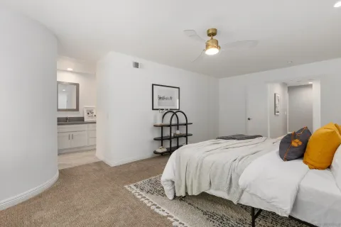 a bedroom with a bed and cabinets