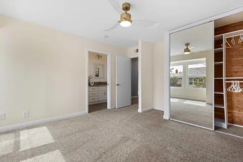 an empty room with closet and windows