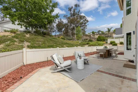 a view of a terrace with a bench and trees