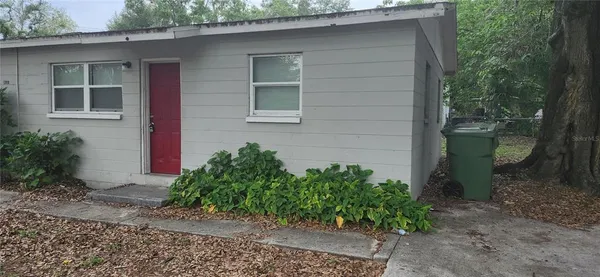 a couple of potted plants in front of door
