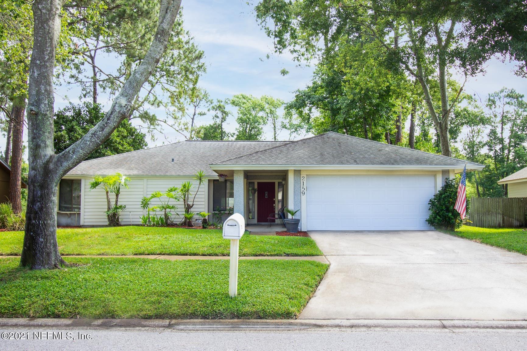 a front view of house with yard and green space
