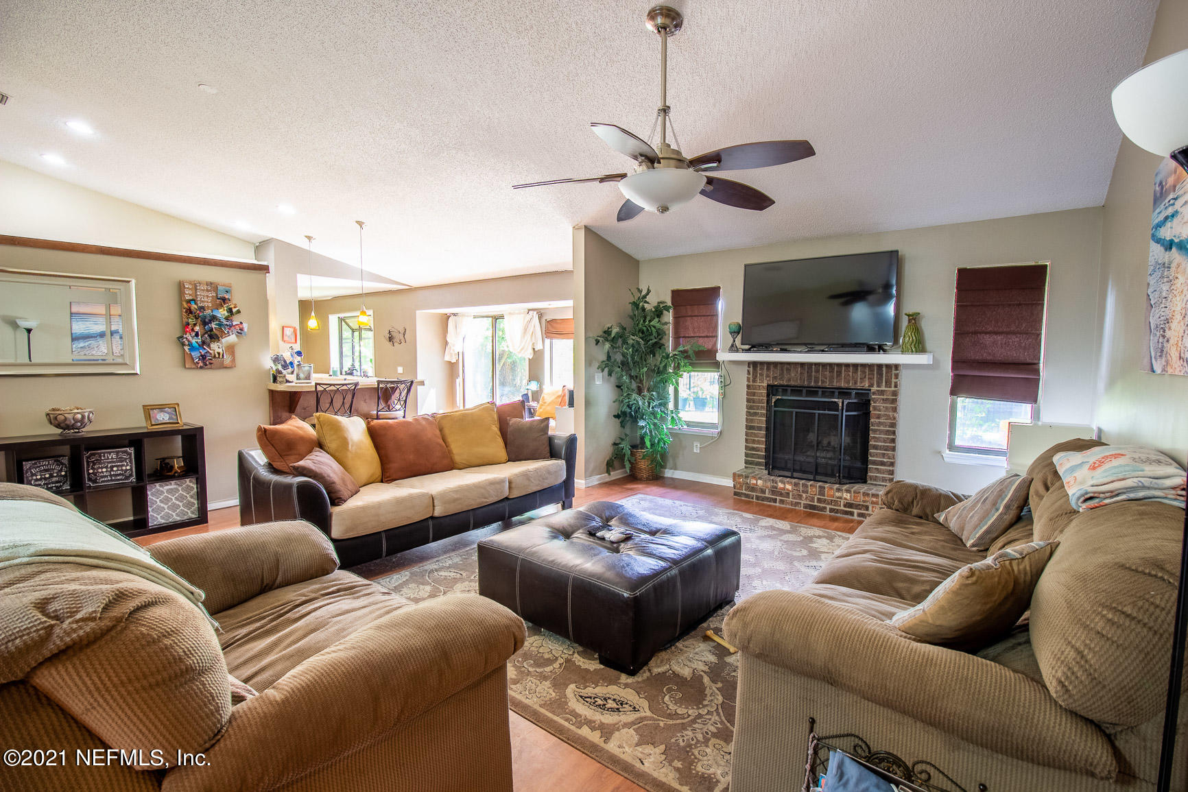 2159 Deer Run Trail Jacksonville, FL 32246 - Photo 5 of 15 a living room with furniture a fireplace and a flat screen tv