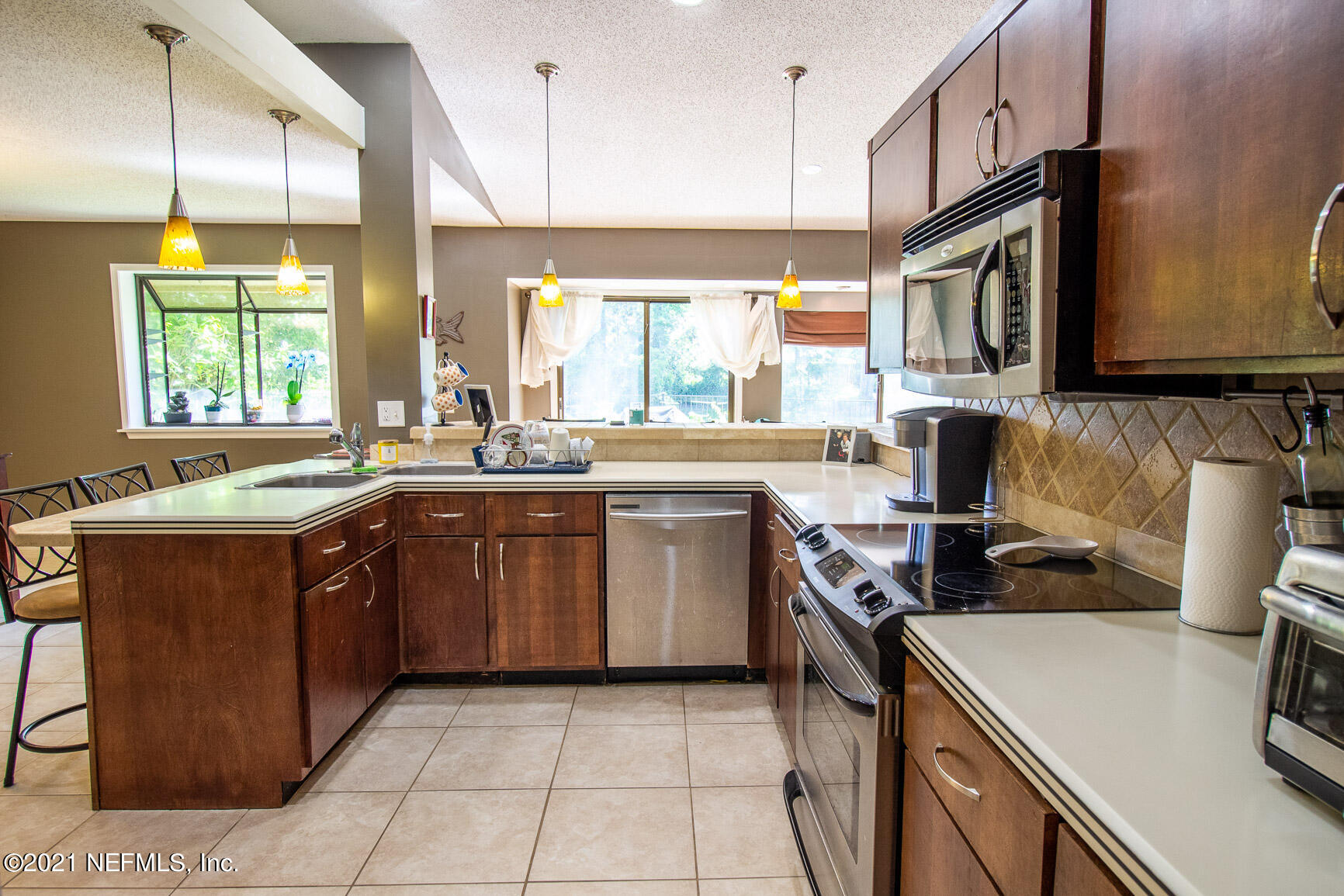 2159 Deer Run Trail Jacksonville, FL 32246 - Photo 6 of 15 a kitchen with a sink stove top oven and microwave