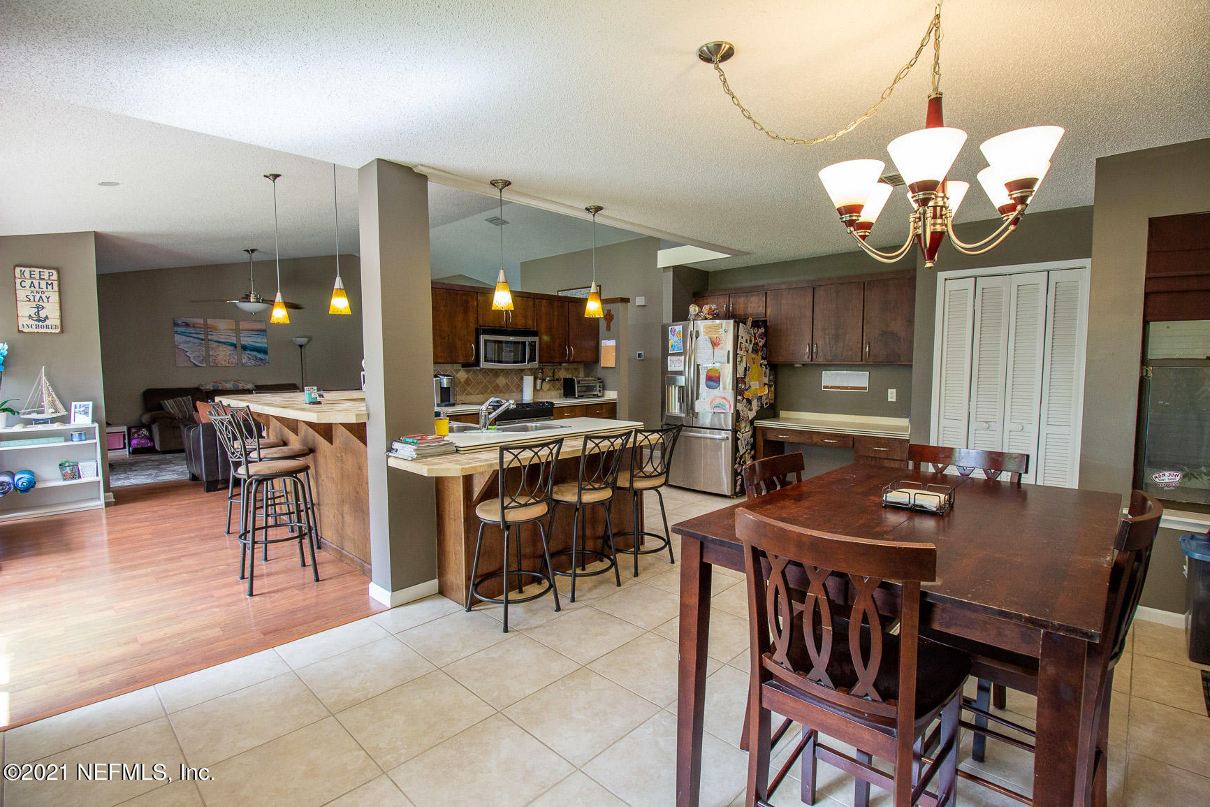 2159 Deer Run Trail Jacksonville, FL 32246 - Photo 7 of 15 a dining room filled chandelier and kitchen view