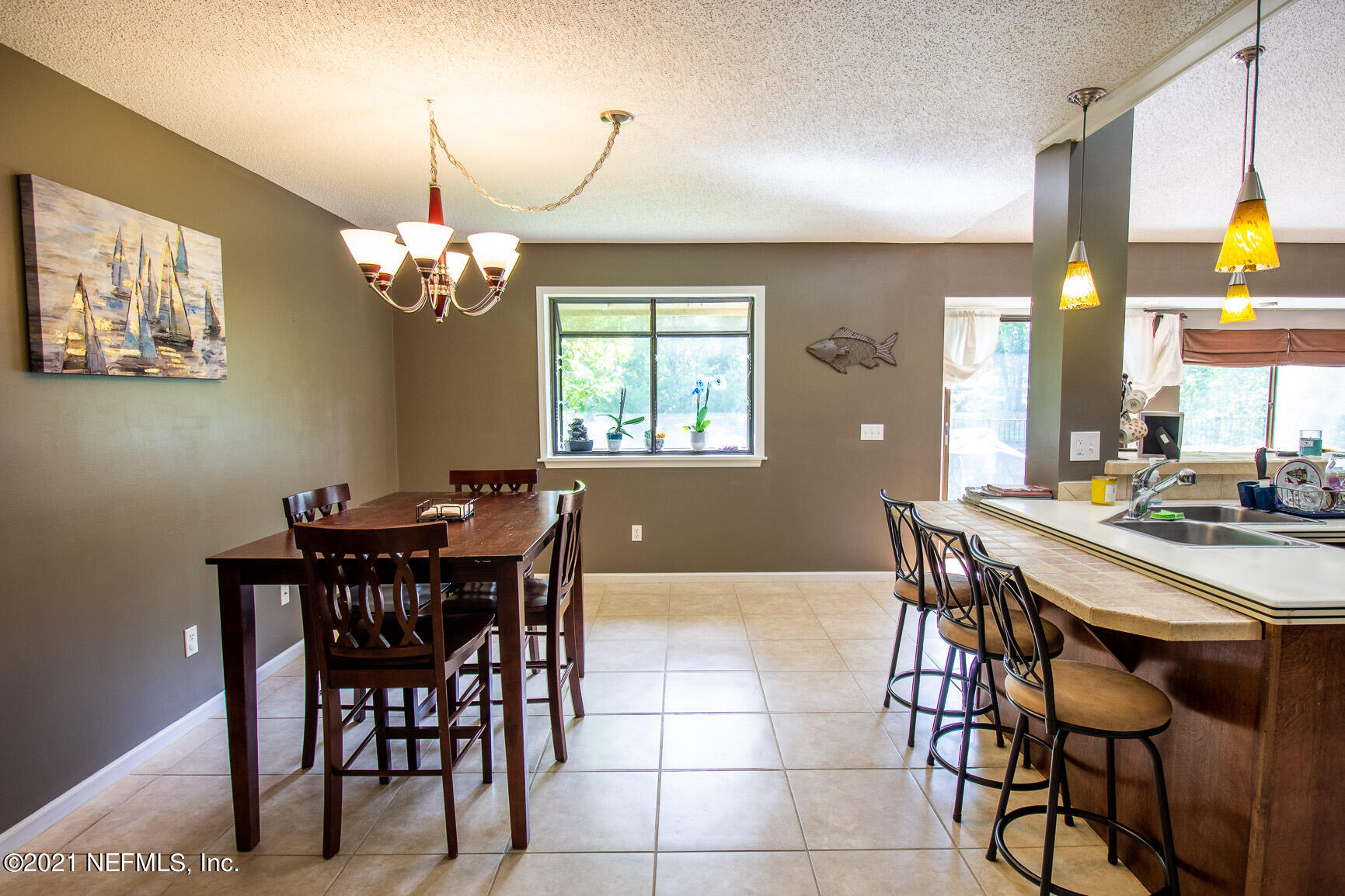 2159 Deer Run Trail Jacksonville, FL 32246 - Photo 9 of 15 a view of a dining room with furniture and chandelier