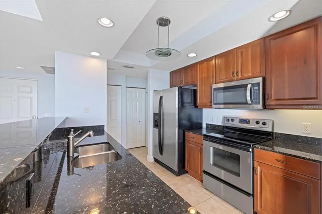 a kitchen with stainless steel appliances a stove a microwave and a refrigerator