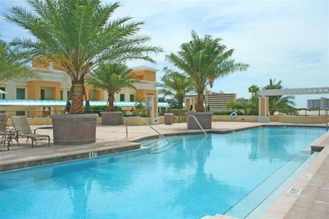 a view of a swimming pool with outdoor seating