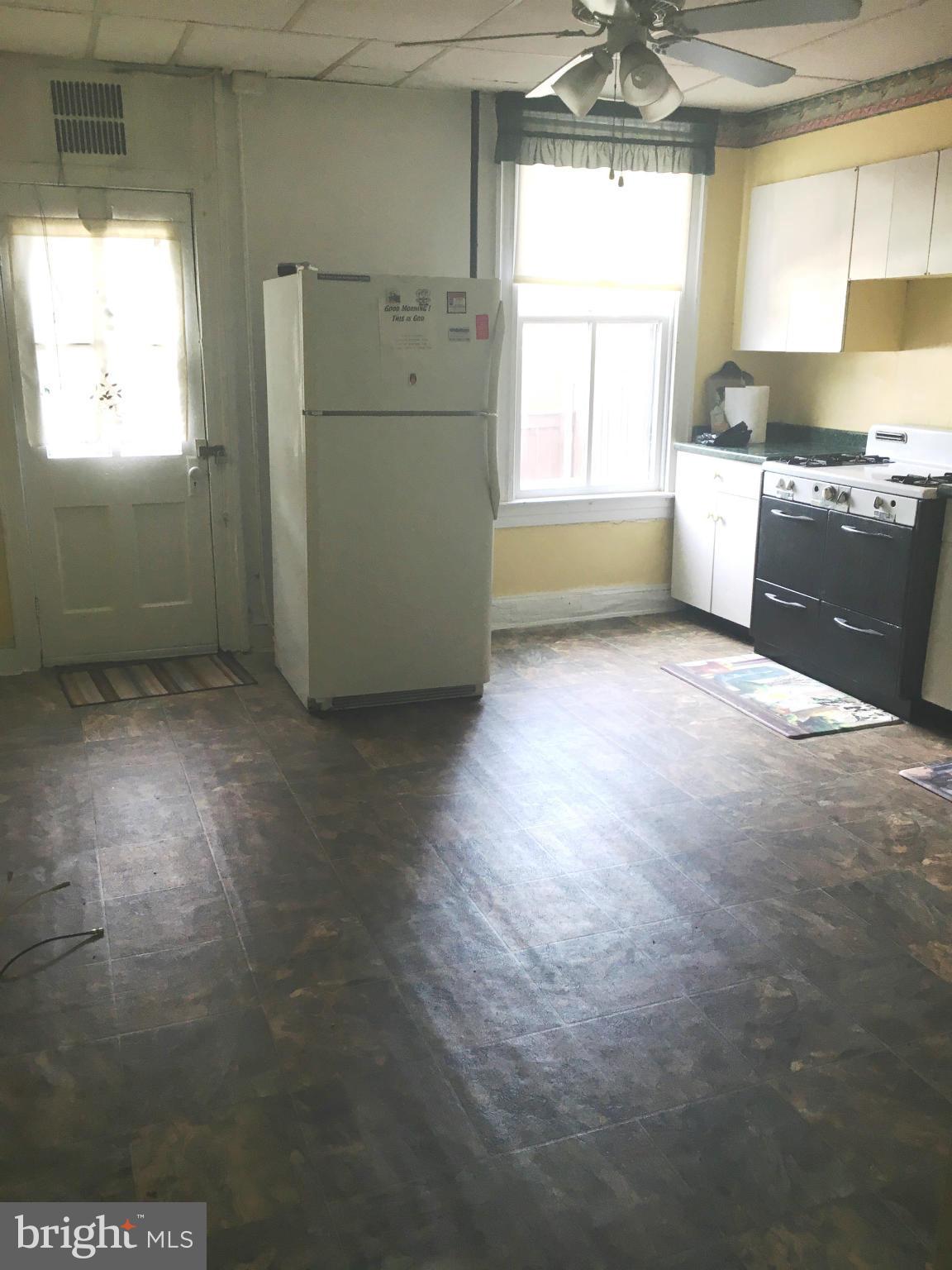 3615 Keswick Road Baltimore, MD 21211 - Photo 4 of 20 a view of a kitchen with a sink dishwasher and wooden floor