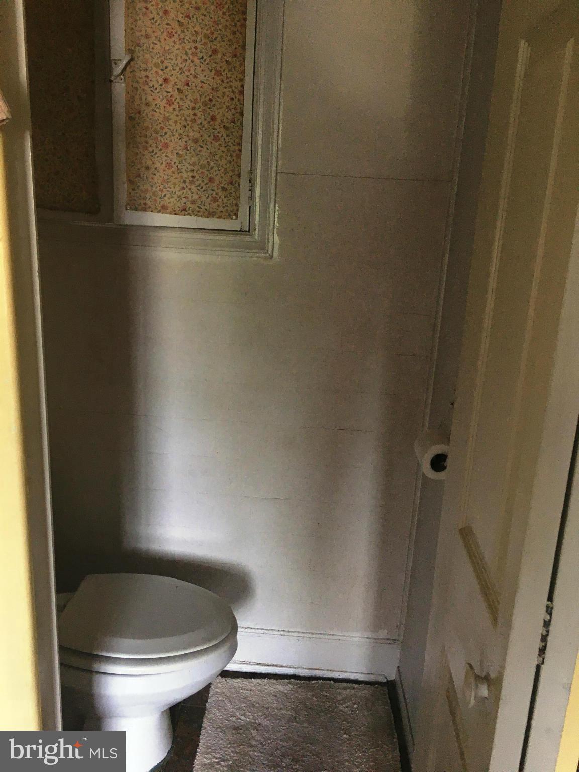 3615 Keswick Road Baltimore, MD 21211 - Photo 5 of 20 a bathroom with a toilet and a shower