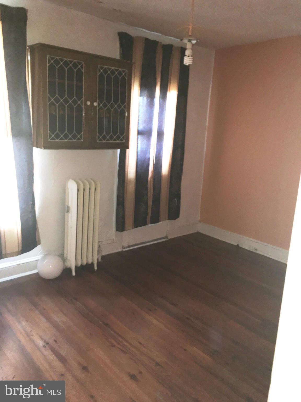 3615 Keswick Road Baltimore, MD 21211 - Photo 8 of 20 an empty room with wooden floor and windows