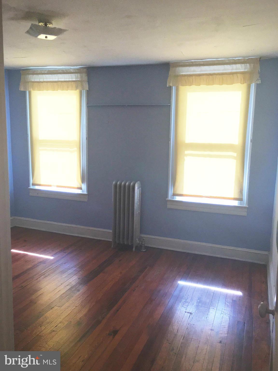 3615 Keswick Road Baltimore, MD 21211 - Photo 9 of 20 a view of an empty room with wooden floor and a window