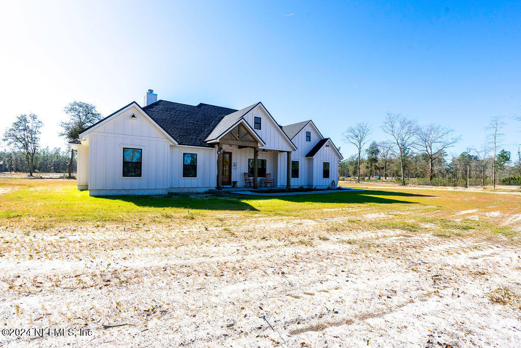 35364 Quail Road Callahan, FL 32011 - Photo 1 of 40 a house view with a swimming pool in front of it
