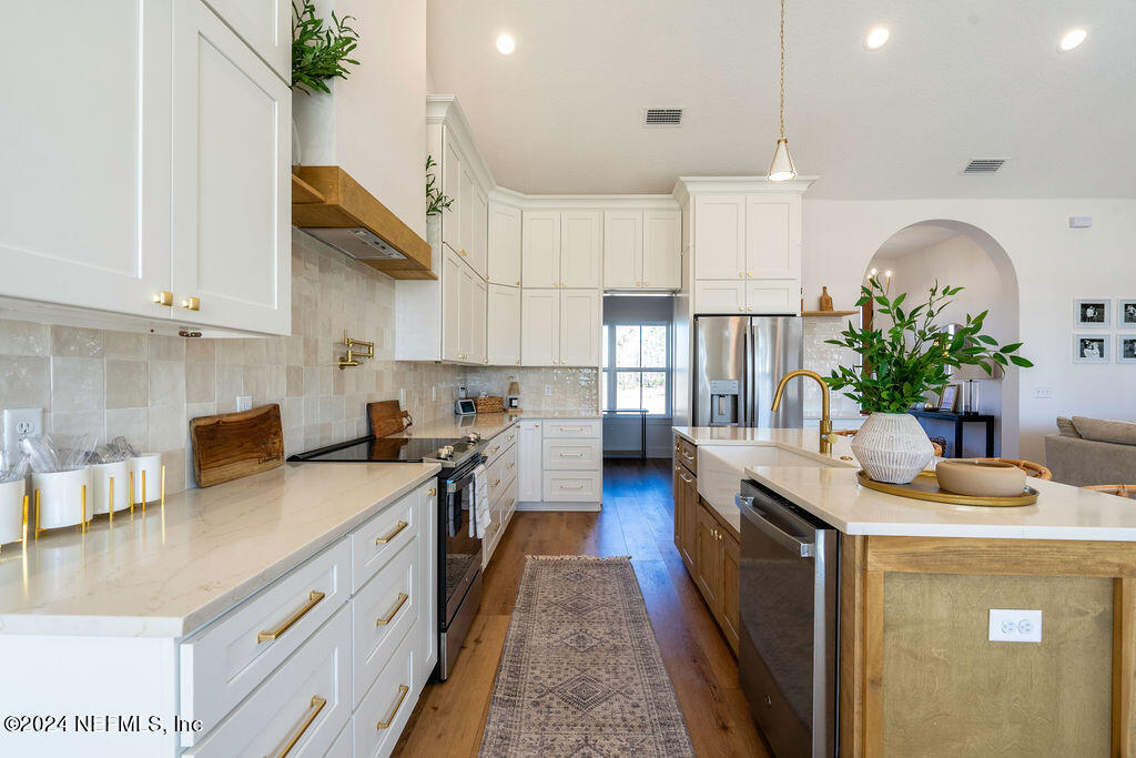 35364 Quail Road Callahan, FL 32011 - Photo 14 of 40 a kitchen with a sink stove and cabinets