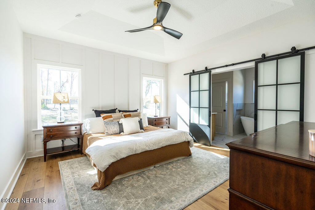 35364 Quail Road Callahan, FL 32011 - Photo 18 of 40 a bedroom with a large bed and a chandelier