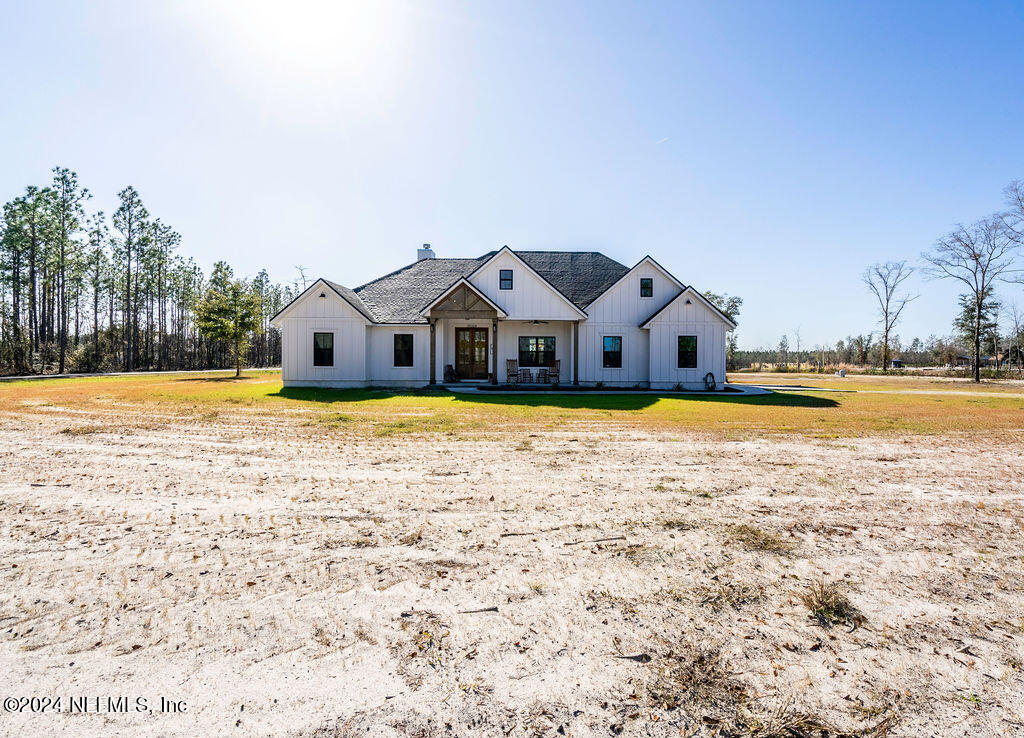 35364 Quail Road Callahan, FL 32011 - Photo 2 of 40 a view of a house with a big yard and large trees