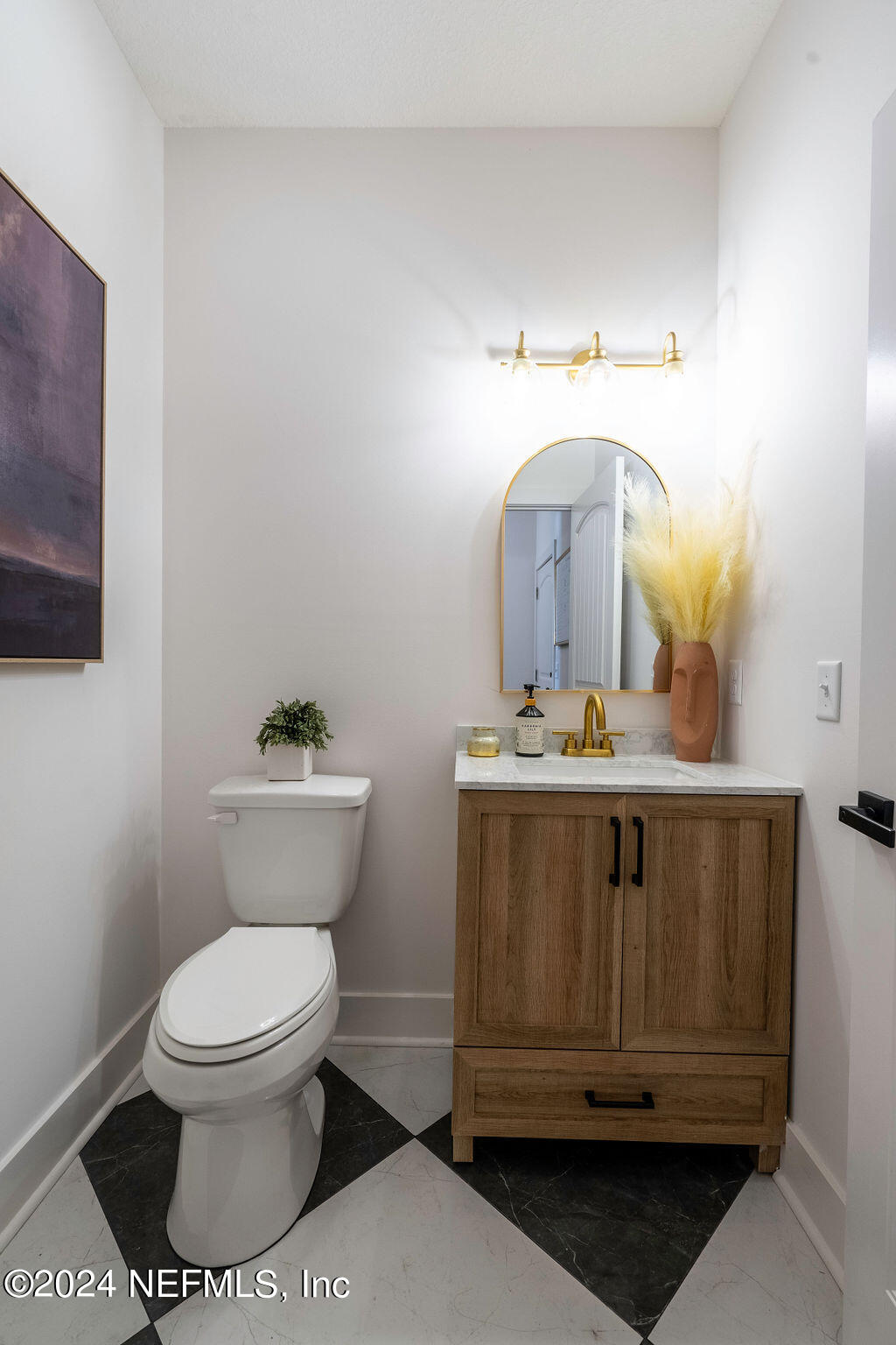 35364 Quail Road Callahan, FL 32011 - Photo 25 of 40 a bathroom with a toilet a sink and mirror