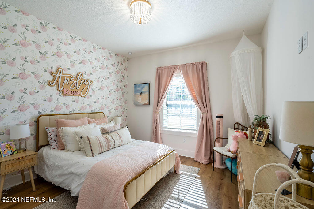 35364 Quail Road Callahan, FL 32011 - Photo 29 of 40 a bedroom with a bed and a chandelier