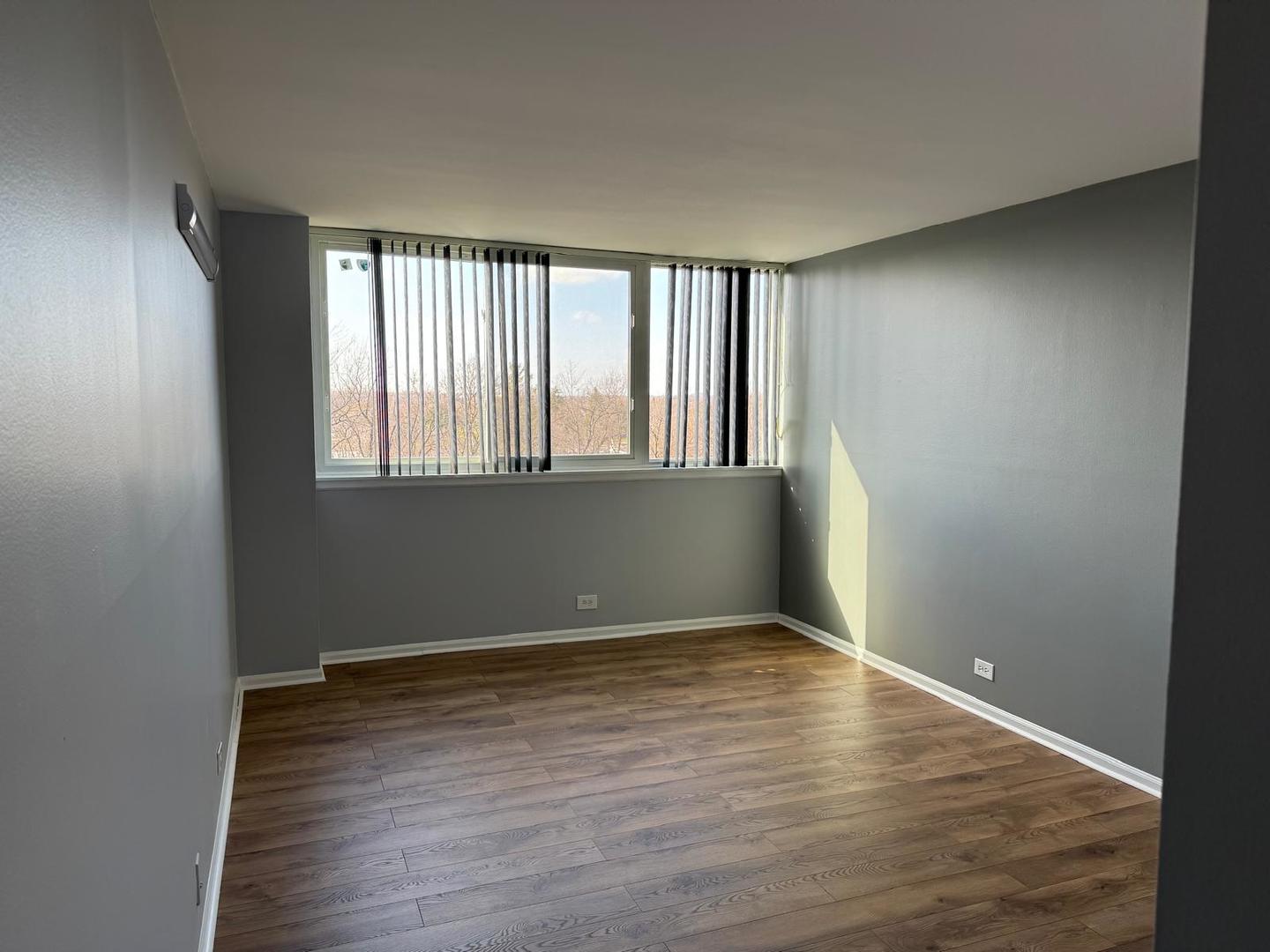 101 Bar Harbour Road, Unit 6A Schaumburg, IL 60193 - Photo 25 of 32 an empty room with wooden floor and windows