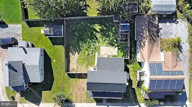 an aerial view of a house with garden space and street view