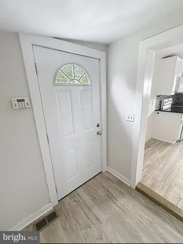 a view of an entryway with wooden floor