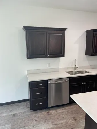 a large kitchen with stainless steel appliances granite countertop a stove a sink and a refrigerator