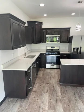 a kitchen with stainless steel appliances a sink and a stove