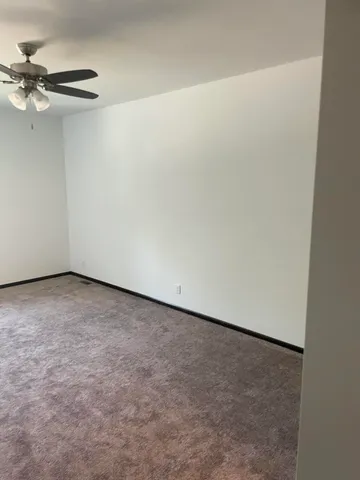 a view of a room with a ceiling fan