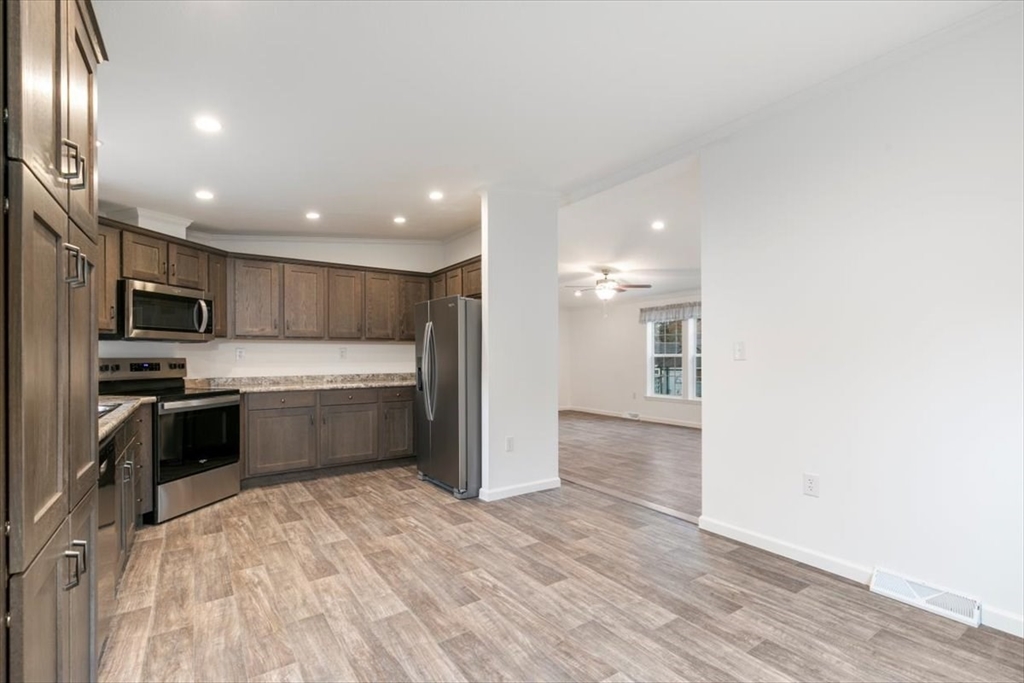 3 B Street Merrimac, MA 01860 - Photo 11 of 26 a kitchen with a refrigerator and a stove top oven