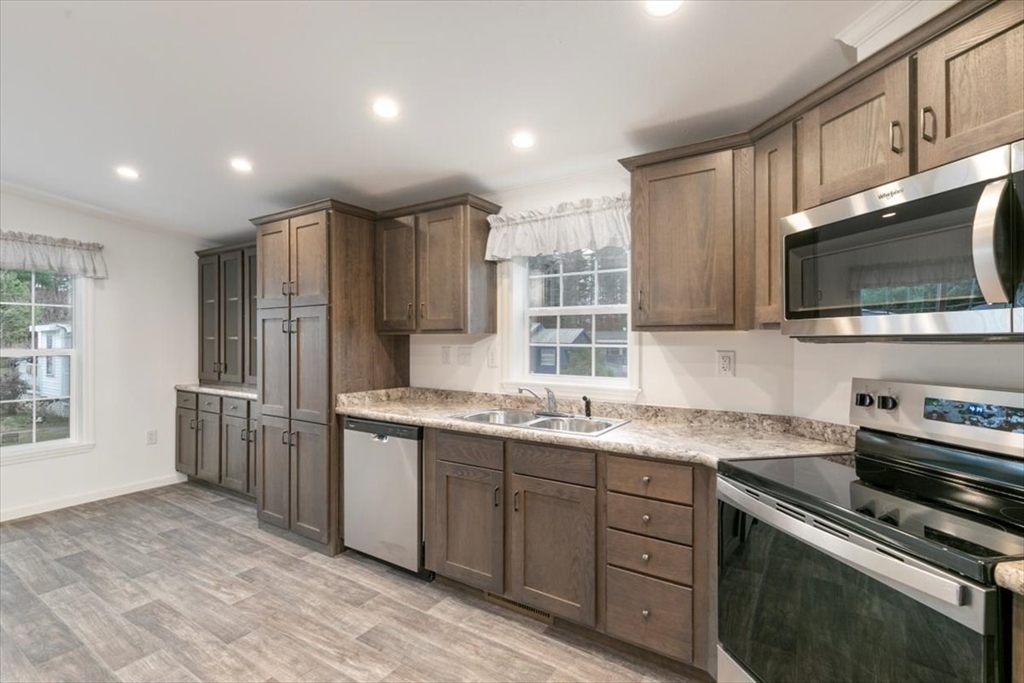 3 B Street Merrimac, MA 01860 - Photo 12 of 26 a kitchen with stainless steel appliances granite countertop a sink stove and refrigerator