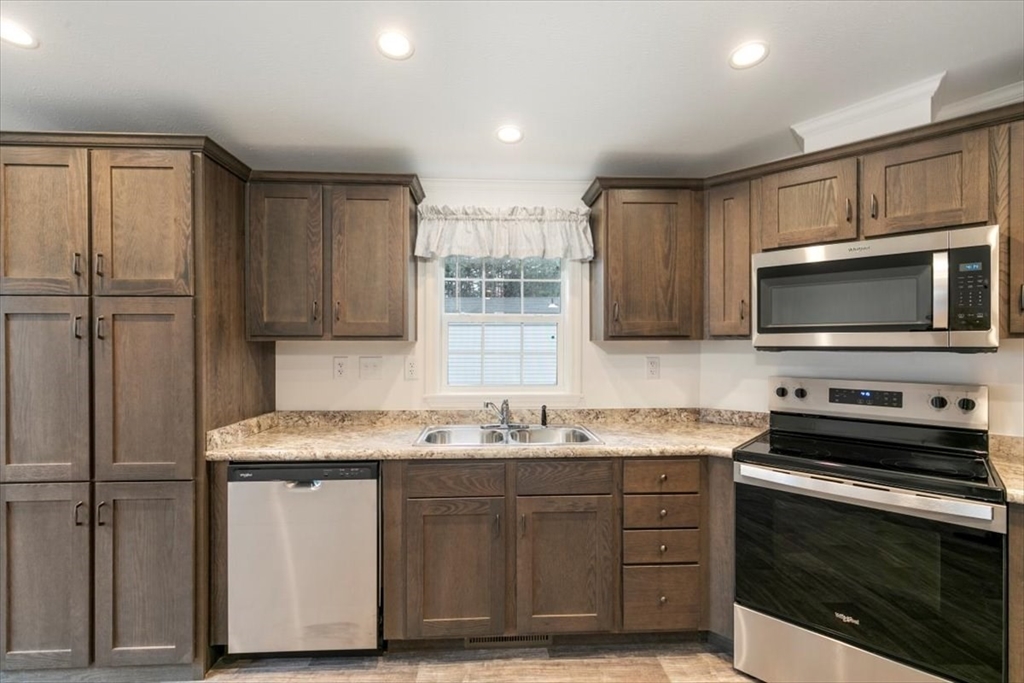 3 B Street Merrimac, MA 01860 - Photo 13 of 26 a kitchen with stainless steel appliances granite countertop a sink stove and microwave