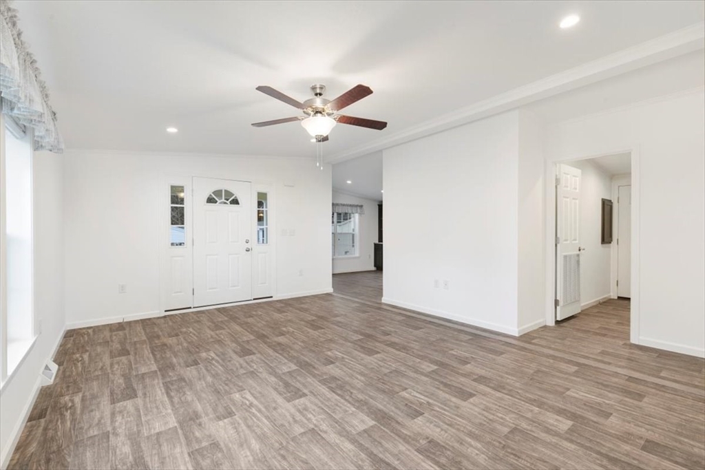 3 B Street Merrimac, MA 01860 - Photo 7 of 26 a view of an empty room with wooden floor and a ceiling fan
