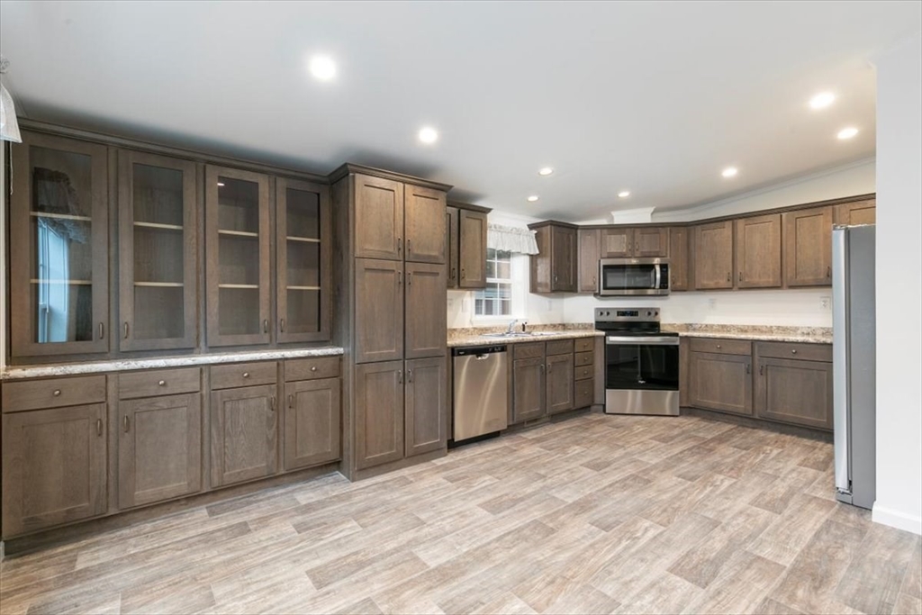 3 B Street Merrimac, MA 01860 - Photo 10 of 26 a kitchen with stainless steel appliances granite countertop a stove sink and cabinets