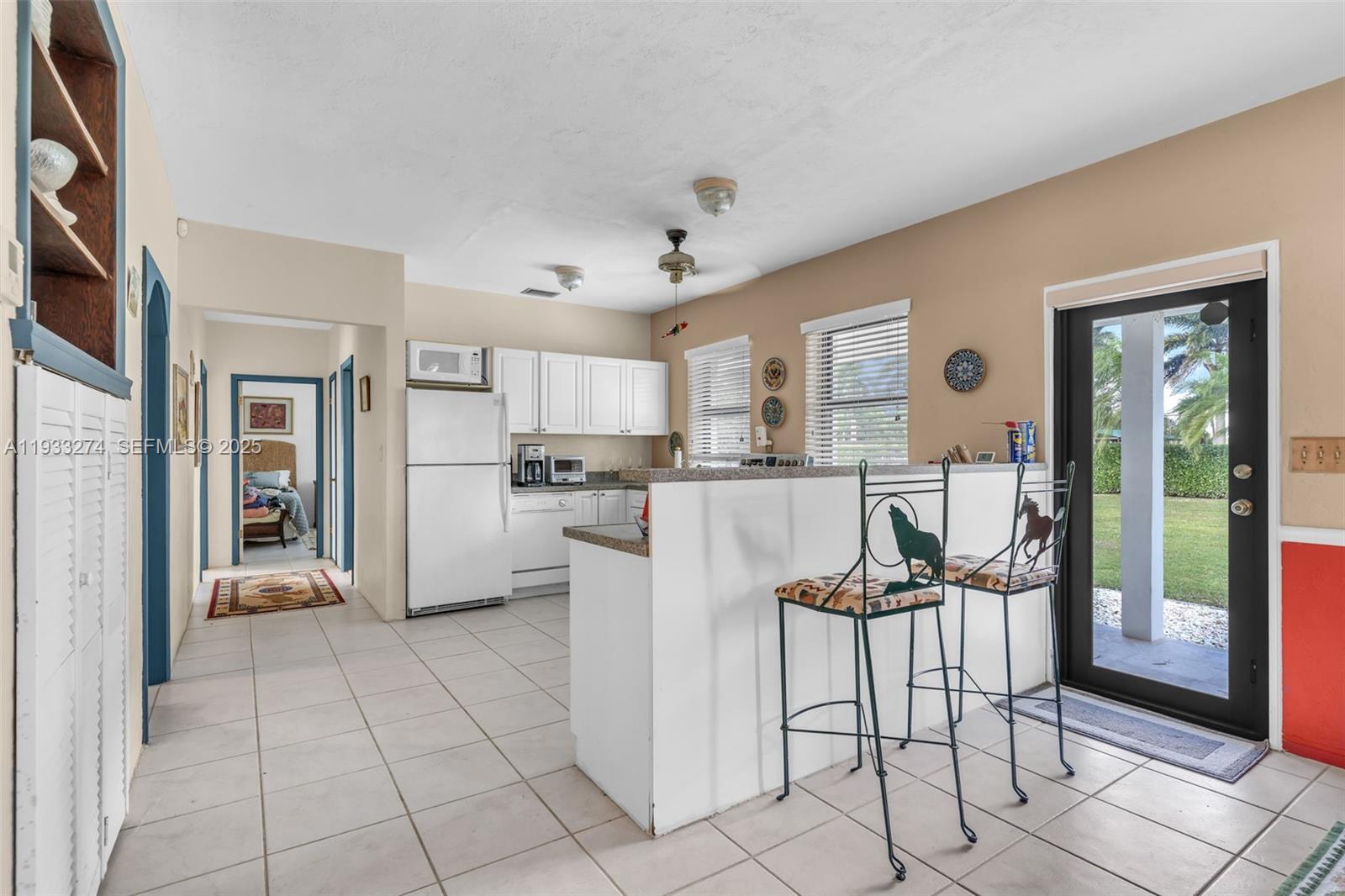 18900 Southwest 224th Street Miami, FL 33170 - Photo 14 of 23 a view of a kitchen with furniture and refrigerator