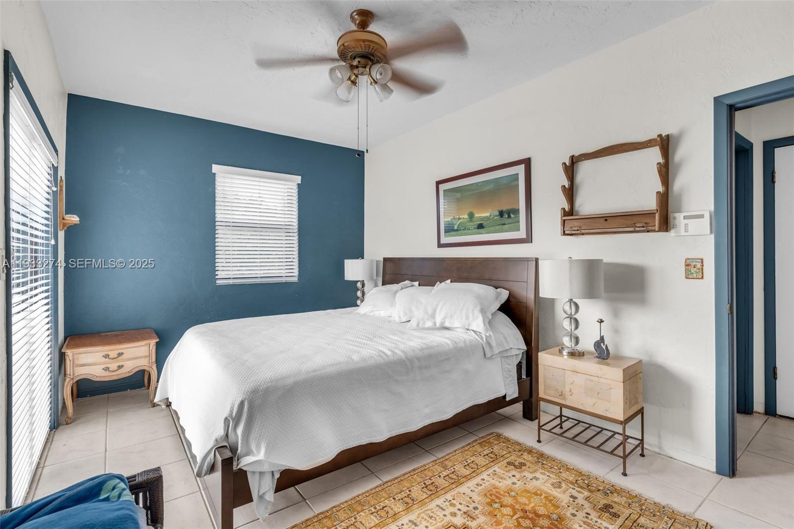 18900 Southwest 224th Street Miami, FL 33170 - Photo 15 of 23 a bedroom with a bed and a chandelier