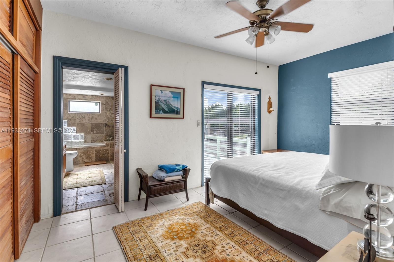 18900 Southwest 224th Street Miami, FL 33170 - Photo 16 of 23 a bedroom with a bed and glass windows
