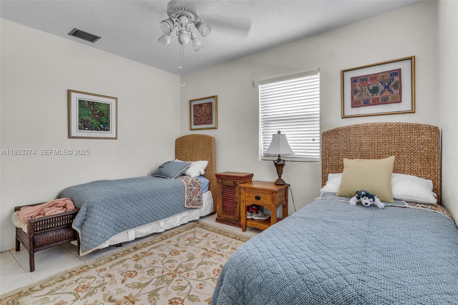 18900 Southwest 224th Street Miami, FL 33170 - Photo 18 of 23 a bedroom with a bed and a chandelier