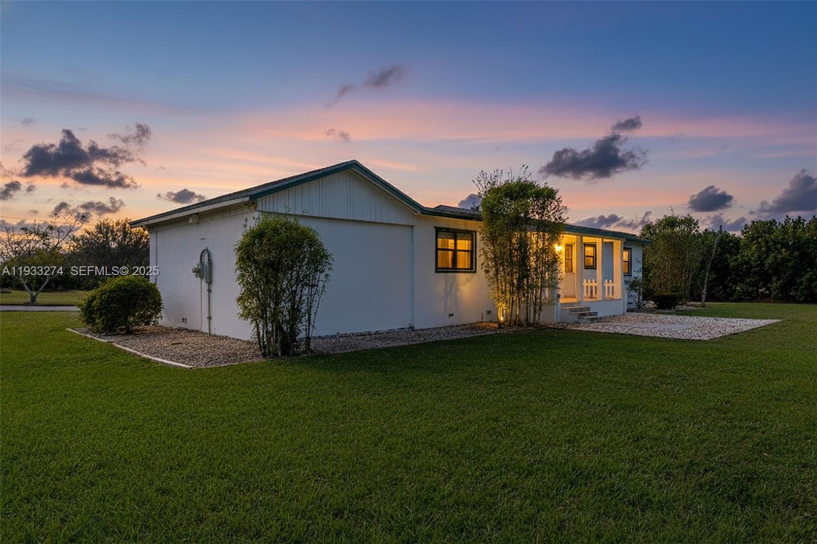 18900 Southwest 224th Street Miami, FL 33170 - Photo 2 of 23 a front view of a house with garden
