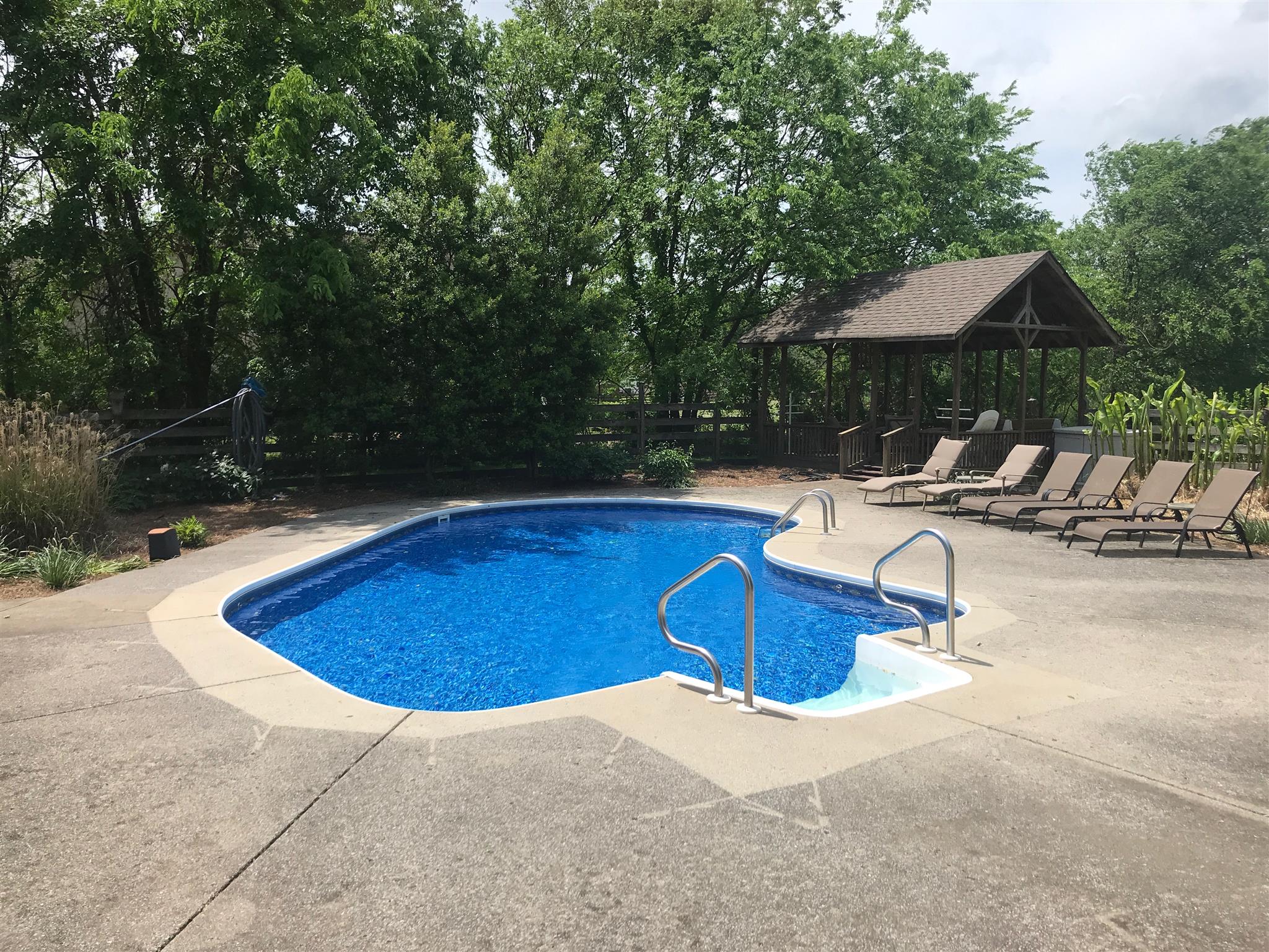 1861 Palmer Road Lebanon, TN 37090 - Photo 9 of 30 a view of swimming pool with table and chairs under an umbrella