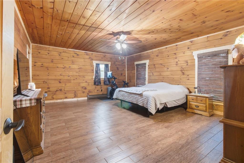 1089 Fire Tower Road Reynoldsville, PA 15851 - Photo 17 of 36 a bedroom with a bed and wooden floor