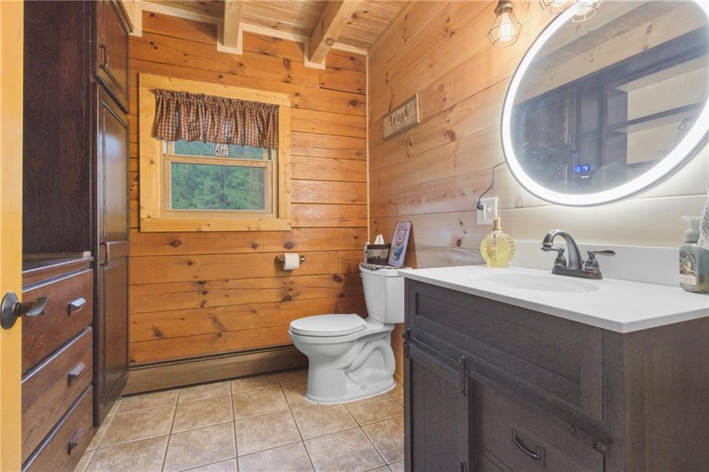 1089 Fire Tower Road Reynoldsville, PA 15851 - Photo 33 of 36 a bathroom with a granite countertop toilet sink and mirror