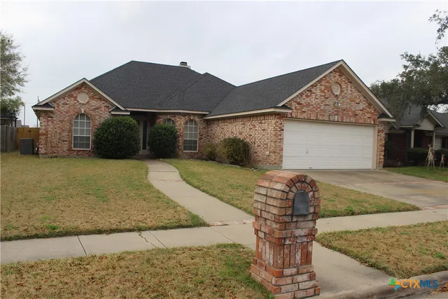 a front view of house with a yard and garage