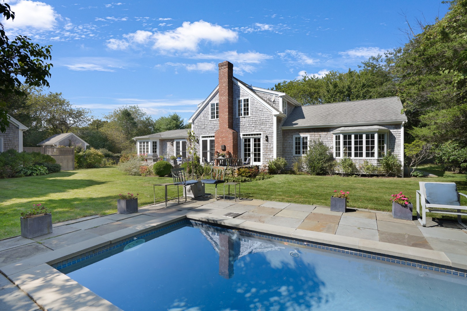 a view of house with outdoor space porch and garden